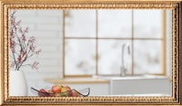 a gold framed mirror in a kitchen with a bowl of fruit